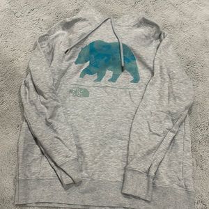 light grey NWOT north face hoodie with blue bear image